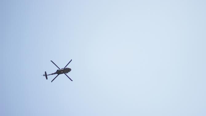 Lookin up at a helicopter from the ground