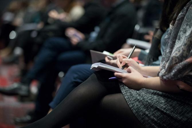 Woman taking notes at a lecture